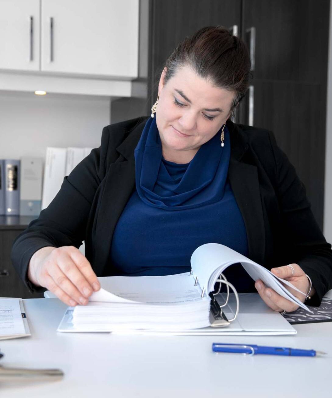 A picture of the office manager of swiftsure law firm reading through documents