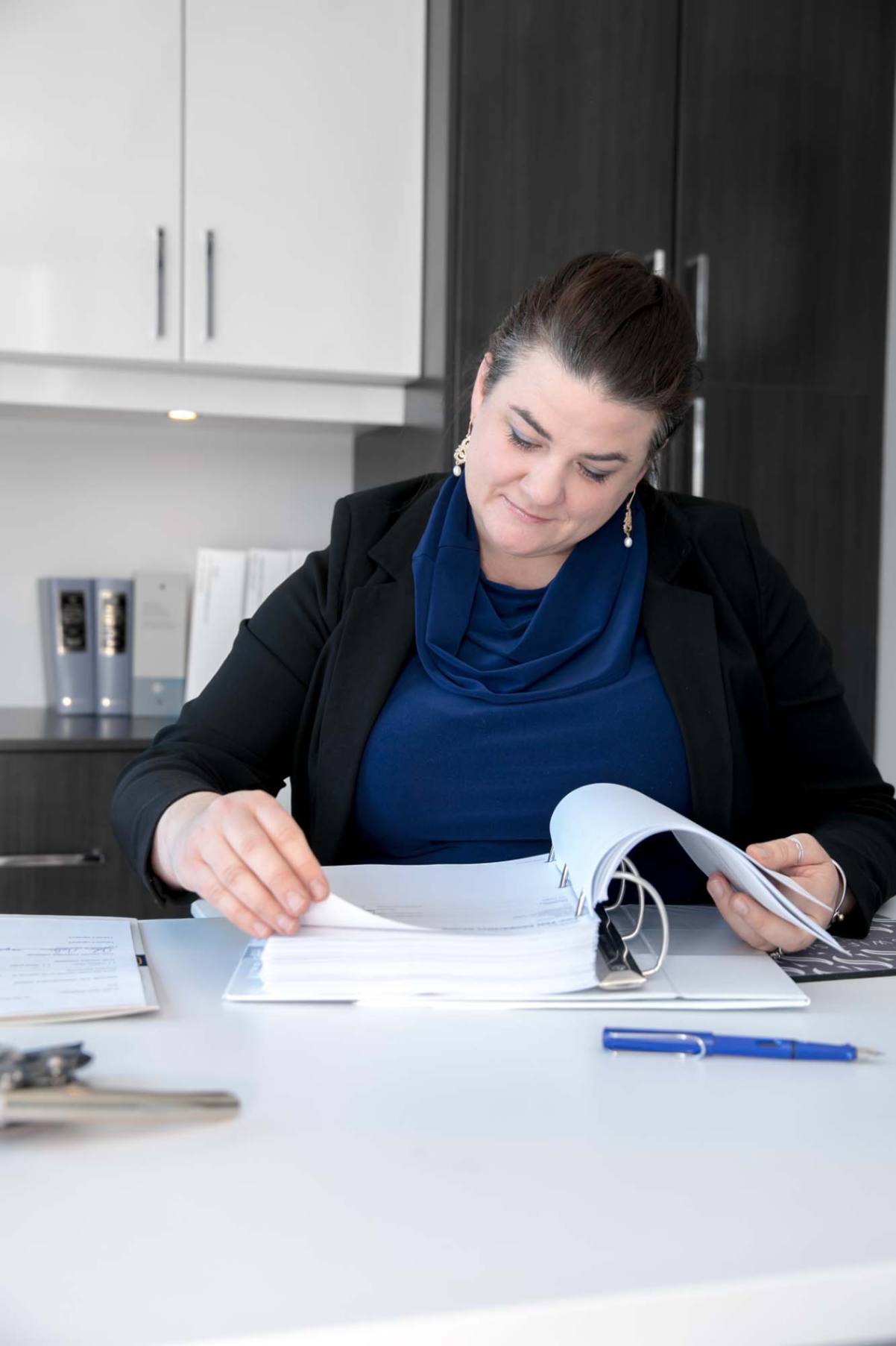 A picture of the office manager of swiftsure law firm reading through documents