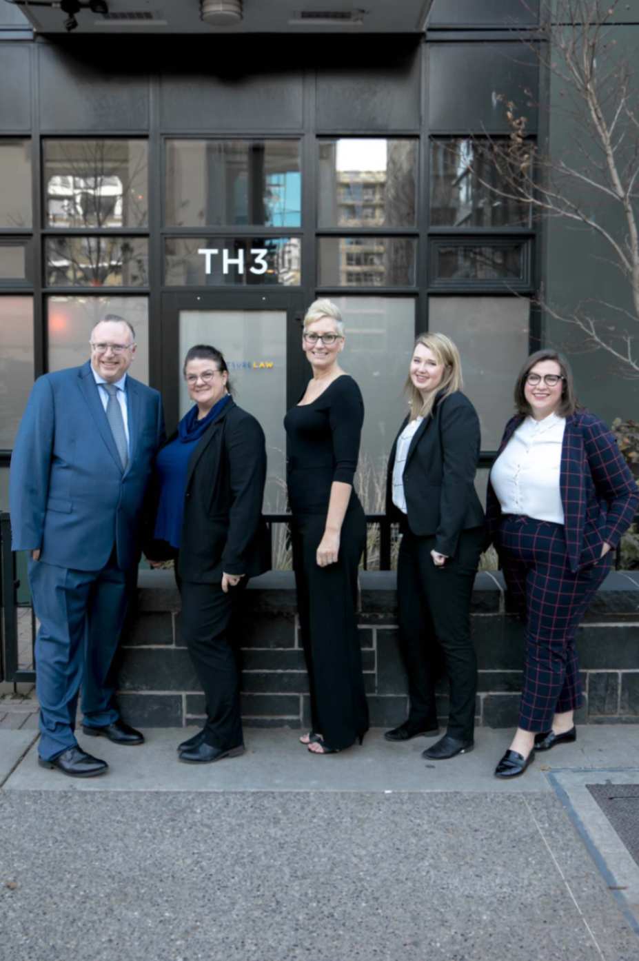 A picture of swift sure law team in front of the building