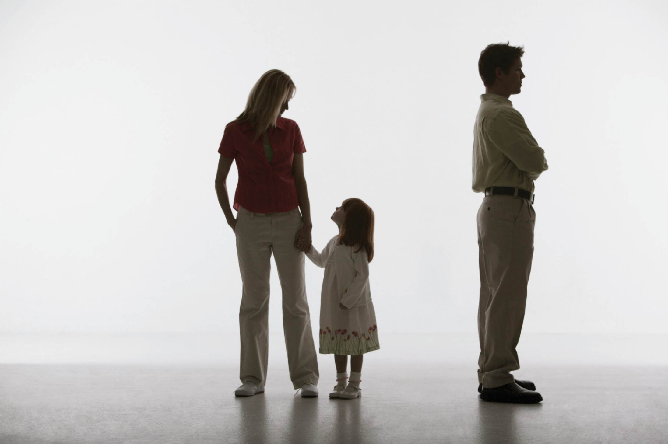 A mother and child look at each other while the father has his back turned to them