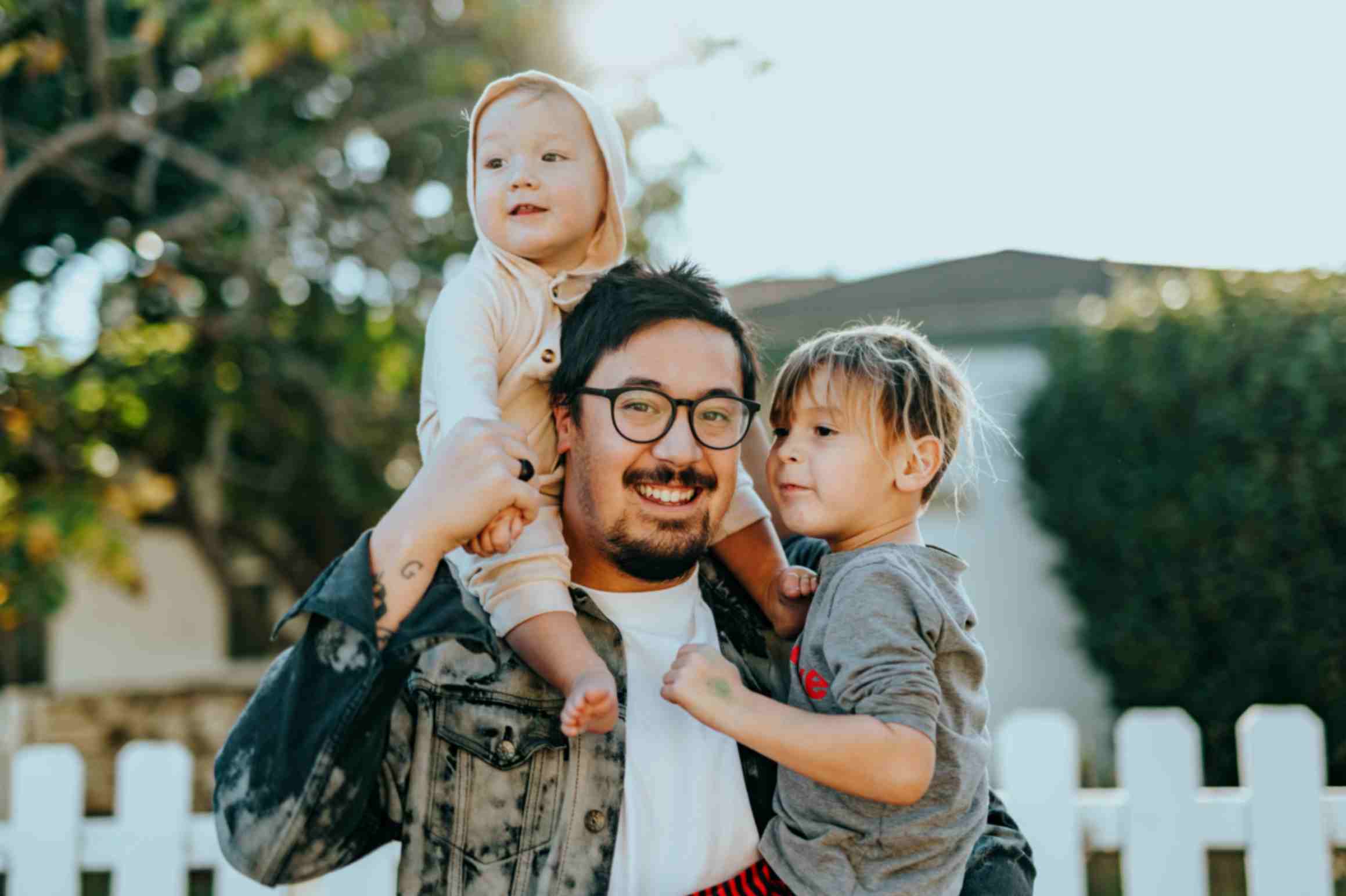 A person holding 2 children