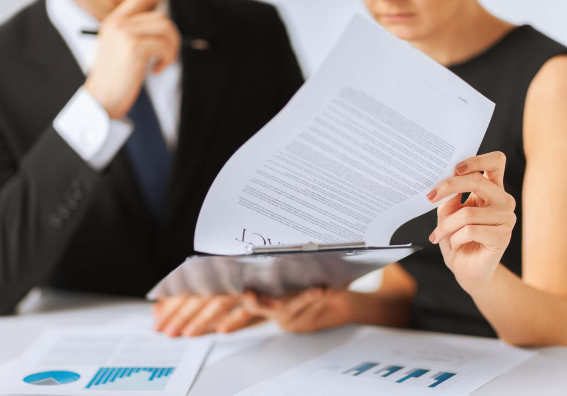 2 people reviewing a contract